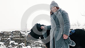 winter horse ride. horseback riding at winter. Happy, smiling woman , holds a little pony by the bridle. family