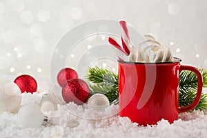 Winter hot drink, cacao with marshmallows or spicy hot chocolate in red cup. Festive vintage background.