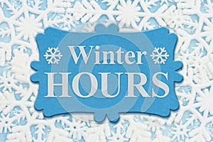 Winter Hours sign with white snowflakes