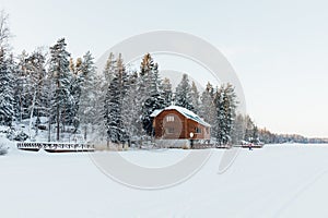Winter house nearby frozen lake