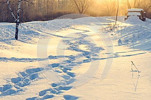 Winter human footprints in the snow at sunrise