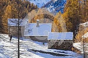 Winter huts covered with snow in the high mountains