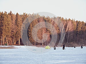 Winter ice fishing, lake, forest, frosty day. fishermans