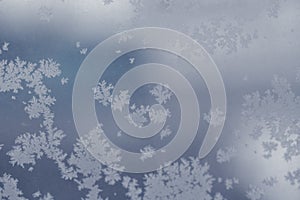 Winter ice pattern on the frozen window. Texture, background for inserting text. New Year theme. Winter. Cold.