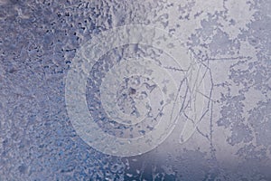 Winter ice pattern on the frozen window. Texture, background for inserting text. New Year theme. Winter. Cold.