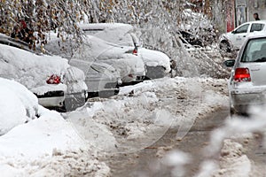 Winter. Ice on roads. Heavy snowfall in the city, snowy icy roads, snowy sidewalks, broken broken branches, uncleaned streets