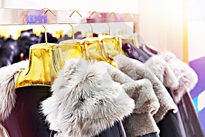 Winter jackets with grey fur collars in clothing store