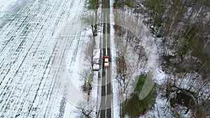 Winter Journey: Lone Vehicle on Snow-Dusted Country Road