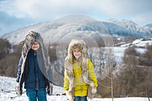 Winter kids. Adorable little girl and boy having fun on snowy day. Children wiht snow.