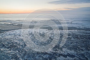 Winter Lake covered with ice crust evening