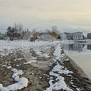 Winter lake shore. Snow covered beach