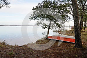 Winter Lake small boat in sand beach in Biscarrosse Landes 40 France photo