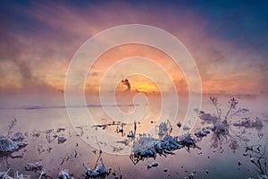 The winter lake sunrise in fog scenic in Daqing oil fields