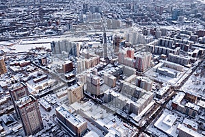 Winter landscape from a aerial view of the city of Novosibirsk, of the streets with a road, tall buildings, houses with roofs