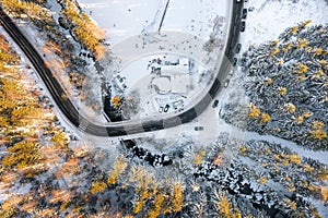 Winter landscape from the air, many winding mountain roads. Winter forest from above and Karpacz village in Poland. Winter