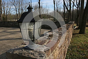 The lantern on the stone wall at the old farm house.