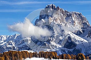 Winter landscape with autumn colored trees in Dolomite Mountains