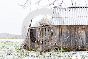 Winter landscape background of wonderland Christmas old woodshed barn at village snow falling
