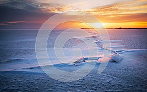 Winter landscape. Beach under snow during sunse