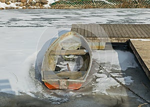 Winter landscape with a boat on the shore of the lake, ice covered lake, Lake Burtnieki