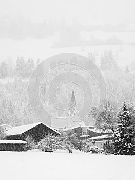 Winter landscape with church during snowfall