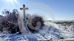 Winter landscape with cross