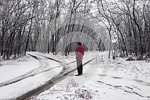 Winter landscape with crossroads and a man