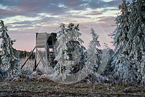 Winter landscape with a deerstand