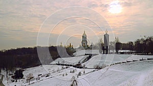 Winter landscape. Domes Of Kiev-Pechersk Lavra. Golden cupolas, Monument to victims of famine in Ukraine.