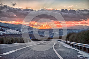 Dramatic sunset sunrise sky over empty freeway.