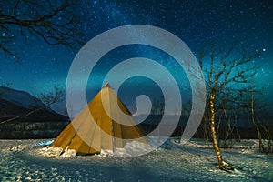 Winter Landscape with Eskimo Tent and Northern Lights. photo