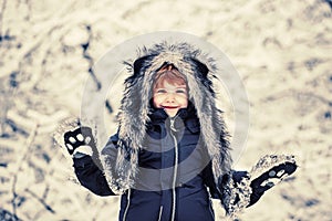 Winter landscape of forest and snow with cute child boy. Enjoying nature wintertime. Happy winter time. Active winter