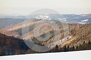 Winter landscape with forested mountains snow covered in Beskydy mountains