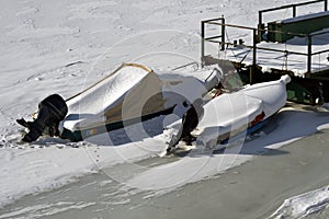 Winter landscape with frozen boats and pontoons 1