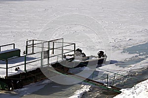 Winter landscape with frozen boats and pontoons 2