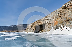 Winter landscape of frozen lake Baikal on a sunny February day. Beautiful blue ice with cracks in the Small Sea Strait