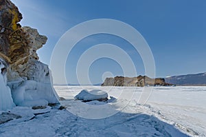 Winter landscape of frozen lake Baikal on a sunny February day. Beautiful blue ice with cracks in the Small Sea Strait
