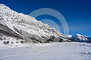 Winter landscape of the frozen Lake Medicine surrounded by the Canadian Rockies in Jasper National Park, Alberta, Canada