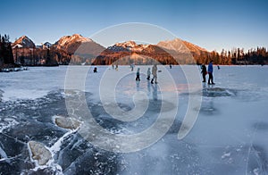 Winter landscape of a frozen mountain lake on a frosty sunny day. Location place Strbske pleso, High Tatras