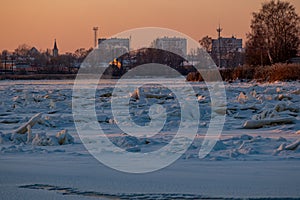 Winter landscape with frozen river with ice drifts