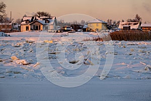 Winter landscape with frozen river with ice drifts