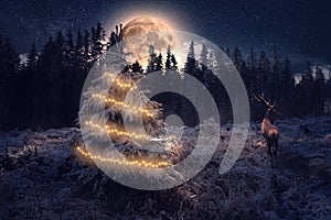 Winter landscape with full moon, Christmas tree and deer