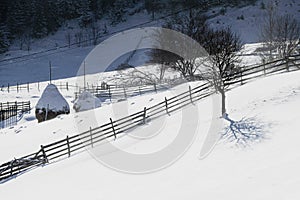 Winter landscape in Fundata village from Rucar Bran pass in Romania at the bottom of Bucegi Mountains
