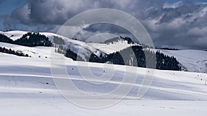 winter landscape gray clouds roll over the snow-covered mountain with pine trees