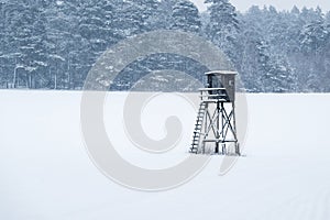 Winter landscape with a high stand for hunters