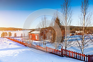 Winter landscape with house at lake