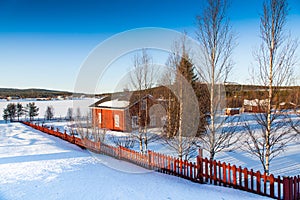 Winter landscape with house at lake in Scandinavia