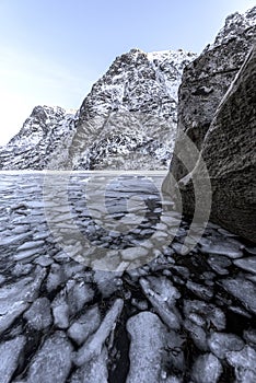 Winter landscape on a lake during islands winter. Snow and ice melting