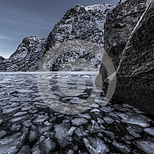 landscape on a lake during Lofoten islands winter. Snow and ice melting