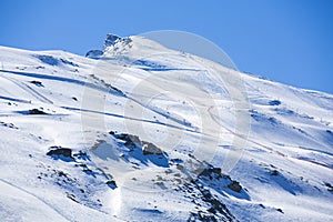 Winter landscape on mountain with ski lift and ski slope.
